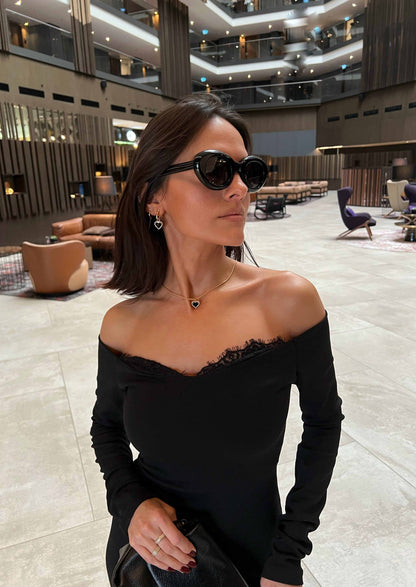 Woman wearing sunglasses in a modern indoor setting