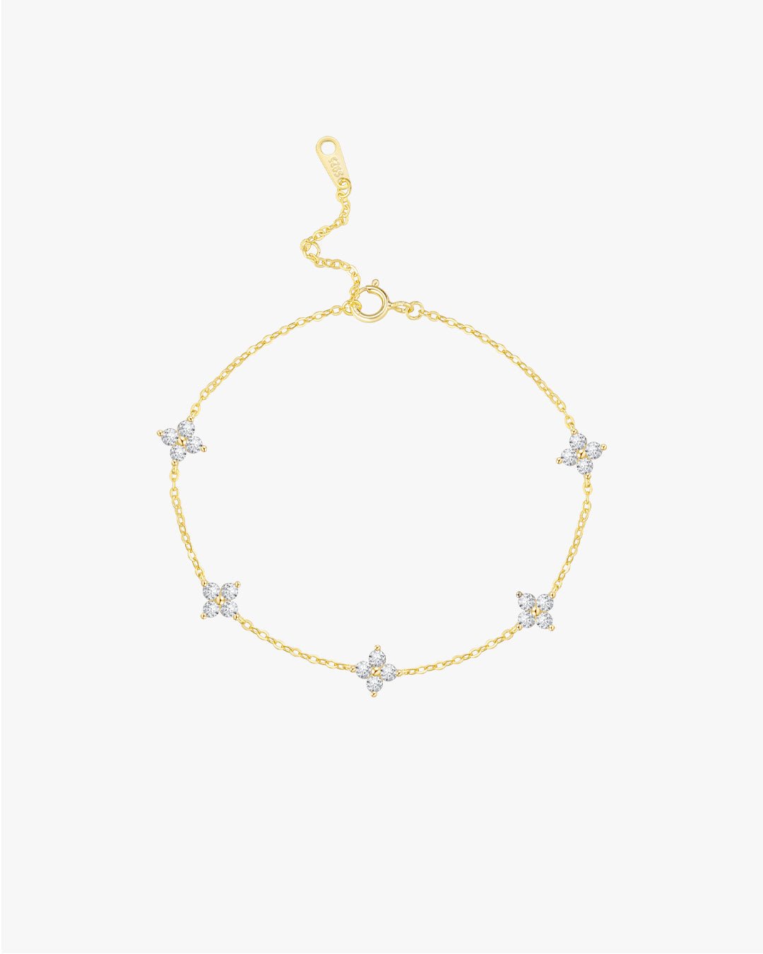 Gold bracelet with star-shaped charms on a light gray background