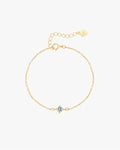 Gold chain bracelet with a central diamond flower pendant, adjustable clasp, and heart-shaped tag. Elegant jewelry accessory for women.