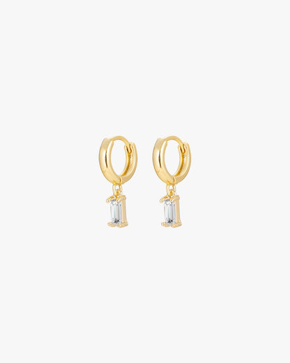 Gold hoop earrings with dangling rectangular crystal charms, minimalist jewelry, elegant accessory, women's fashion, stylish gold earrings.