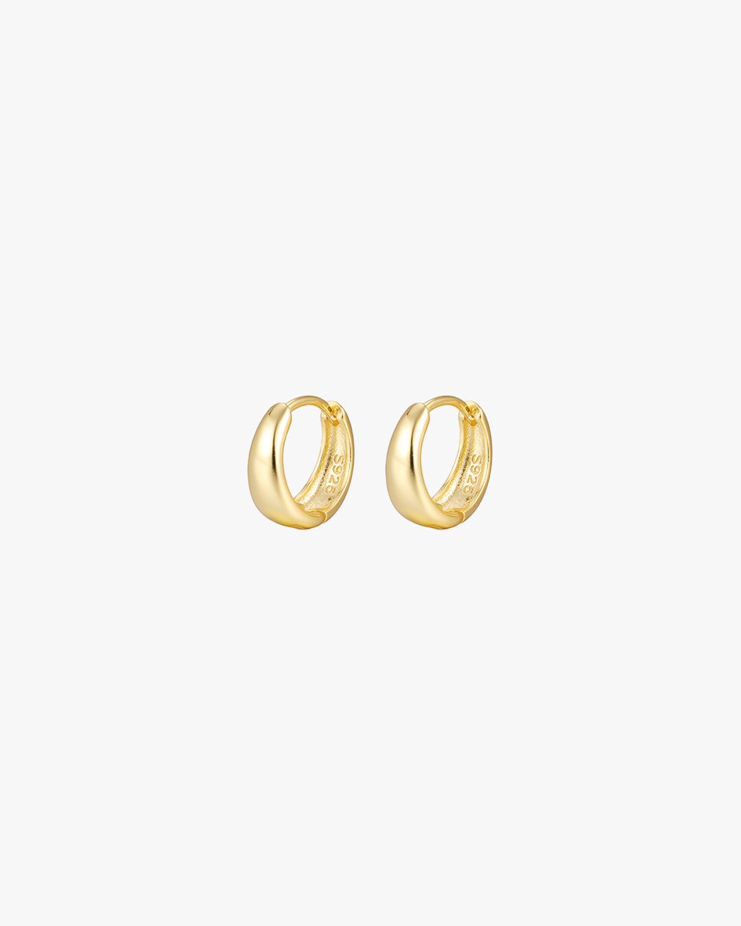 Gold hoop earrings on white background, minimalist jewelry, small round design, elegant fashion accessory, women's gold earrings, chic style.