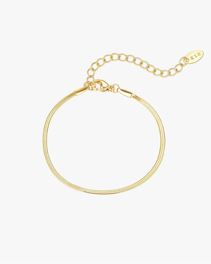 Gold snake chain bracelet with lobster clasp and adjustable extender, featuring a minimalist design. Perfect for elegant jewelry styling.