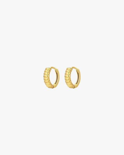 Gold hoop earrings with ribbed texture on white background, minimalist jewelry, fashion accessories, elegant design, women's gold earrings.