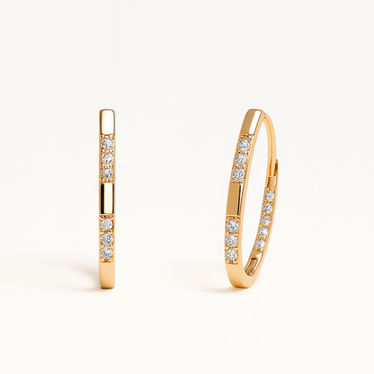 Gold hoop earrings with embedded diamonds on a white background