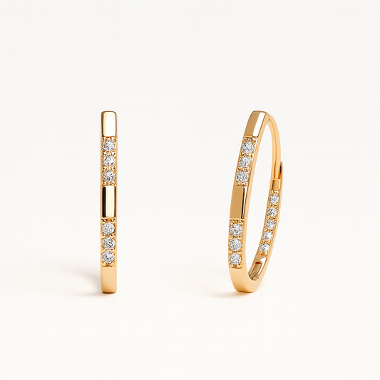 Gold hoop earrings with embedded diamonds on a white background