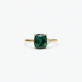 Gold ring with a cushion-cut green gemstone and a small diamond accent, elegant jewelry design, perfect for engagement or special occasions.