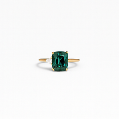 Emerald green gemstone ring with gold band and diamond accent, elegant jewelry, luxury accessory, perfect for engagement or special occasions.