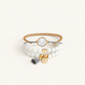 Multistrand bracelet with beads and charms on a white background
