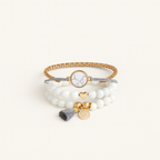 Multistrand bracelet with beads and charms on a white background