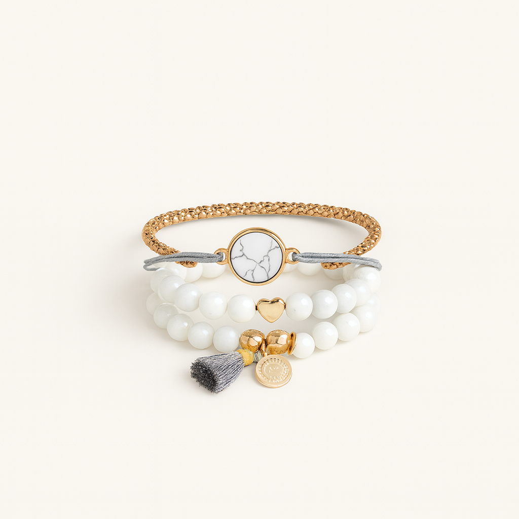 Multistrand bracelet with beads and charms on a white background