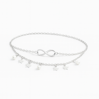 Silver infinity anklet with star and pearl charms, double chain design, elegant jewelry accessory, perfect for fashion-forward styling.