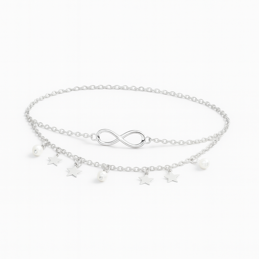 Silver infinity anklet with star and pearl charms, double chain design, elegant jewelry accessory, perfect for fashion-forward styling.