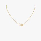 Gold necklace with interlocking rings pendant, minimalist jewelry design, elegant chain, perfect for everyday wear or special occasions.