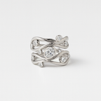 Silver ring with diamond accents on a light gray background