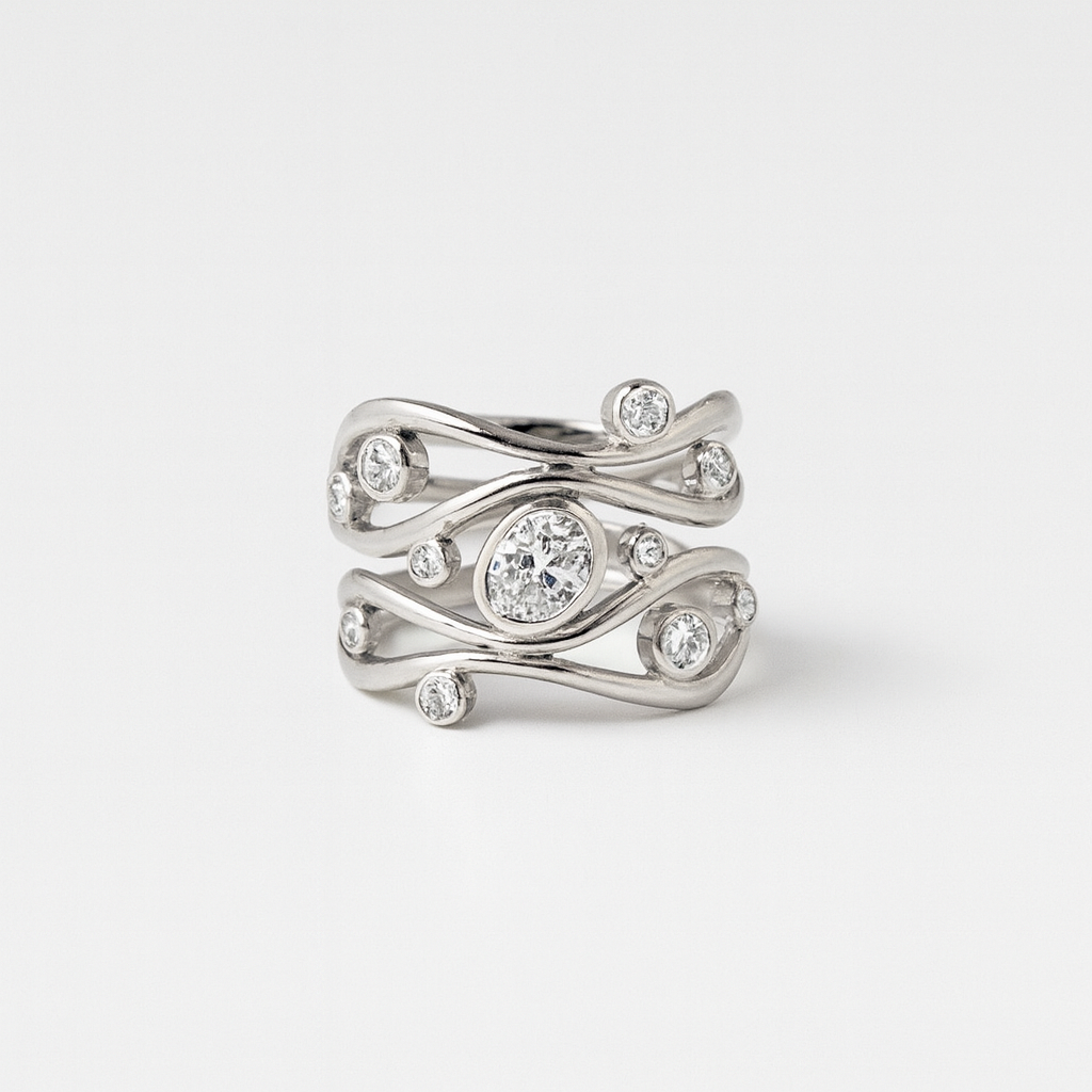 Silver ring with diamond accents on a light gray background