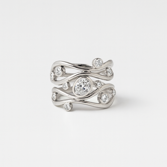 Silver ring with diamond accents on a light gray background