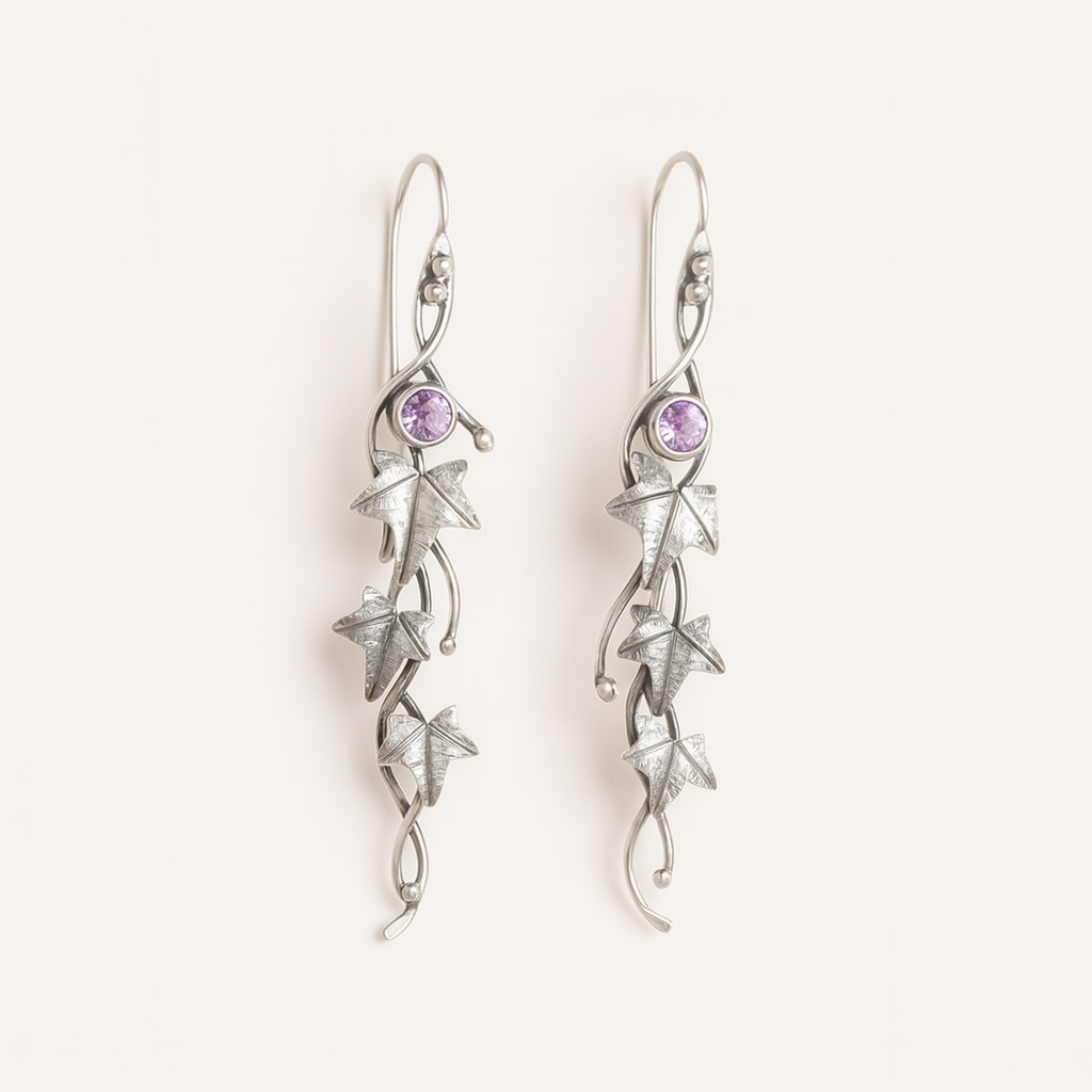 Silver earrings with star designs and purple gemstones on a white background