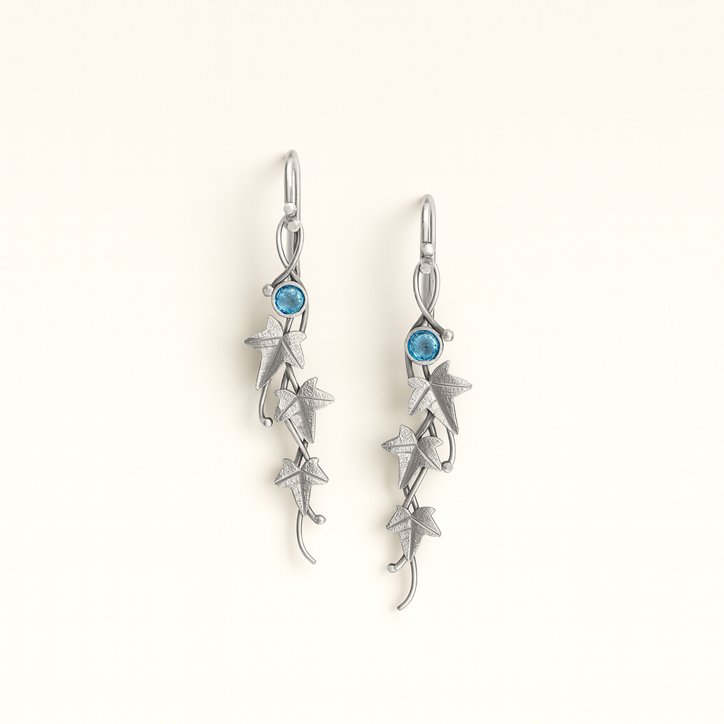 Silver earrings with blue gemstones on a white background
