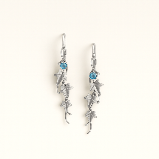 Silver earrings with blue gemstones on a white background