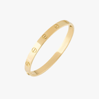Gold Cartier Love Bracelet with screw motif, luxury jewelry, iconic design, unisex fashion accessory, elegant wristwear, high-end style statement.