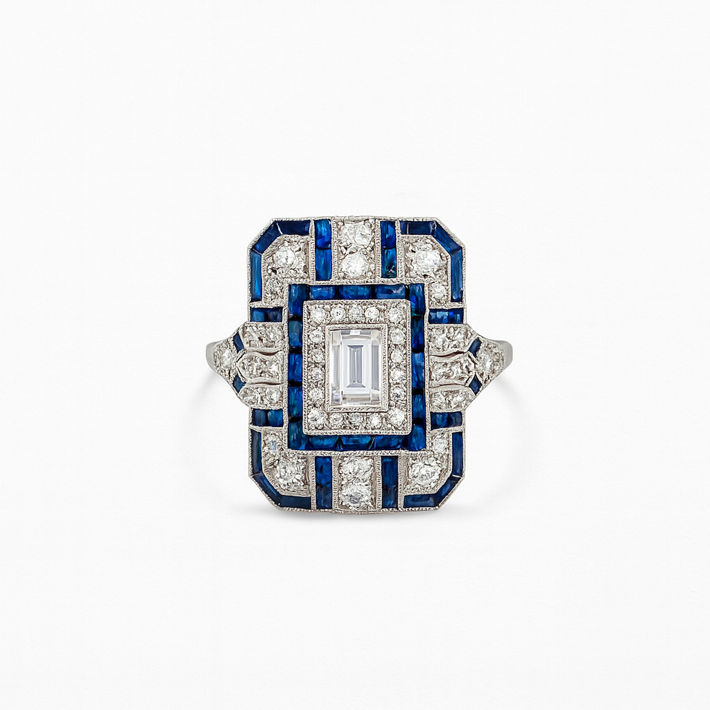 Art Deco style ring with blue and white gemstones on a white background