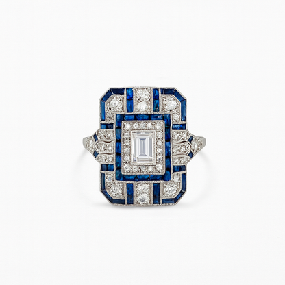 Art Deco style ring with blue and white gemstones on a white background