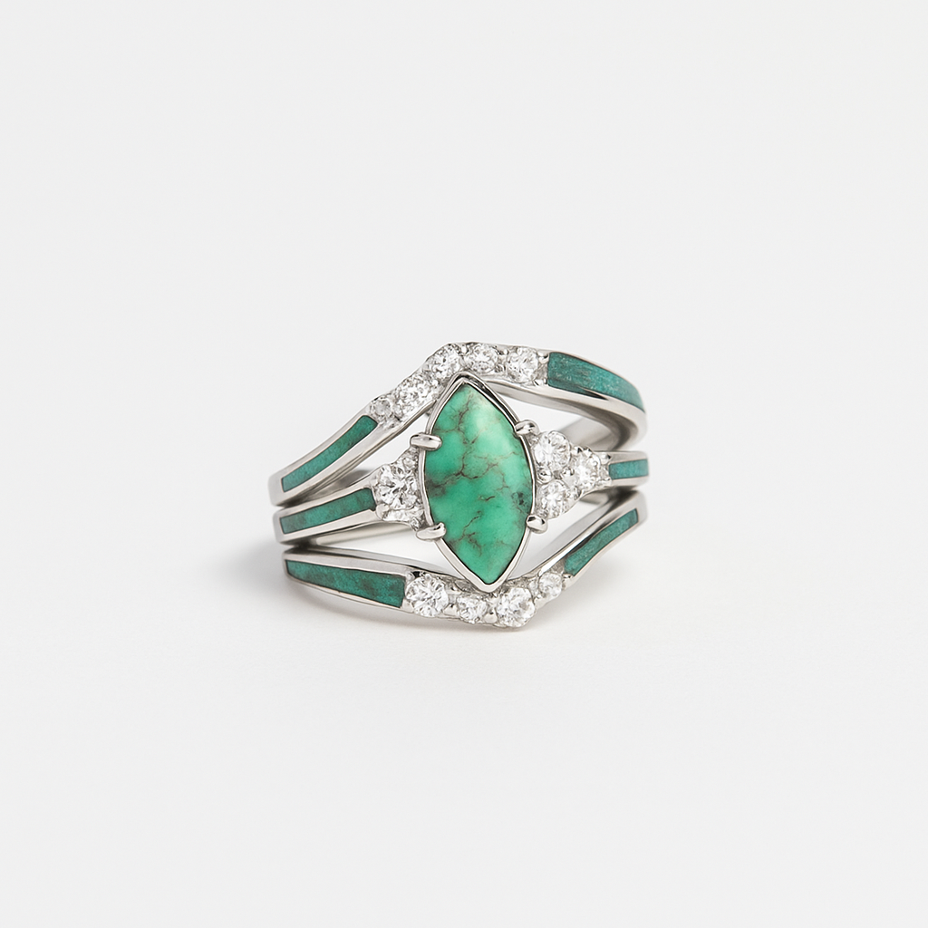 Silver ring with a large green gemstone and smaller clear stones on a white background