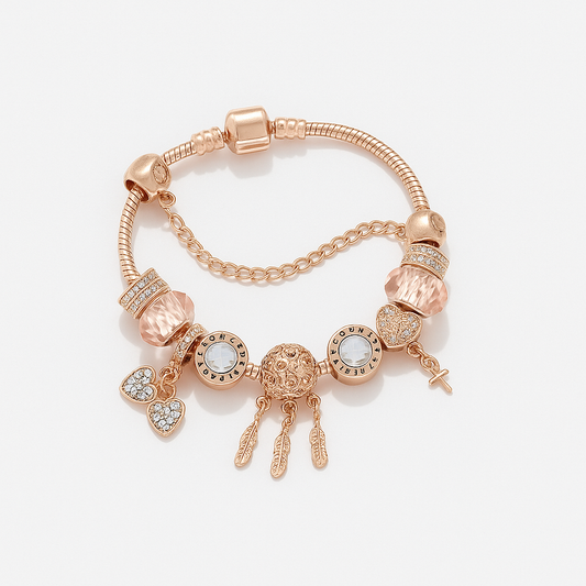 Rose gold bracelet with various charms on a light background