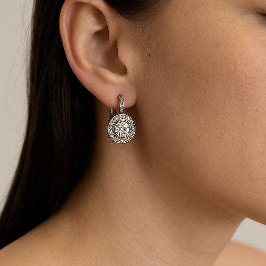 Close-up of a person wearing a silver earring with a circular design.