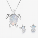 Silver turtle jewelry set with opal inlay, featuring a necklace and matching earrings. Elegant ocean-themed accessories for women.