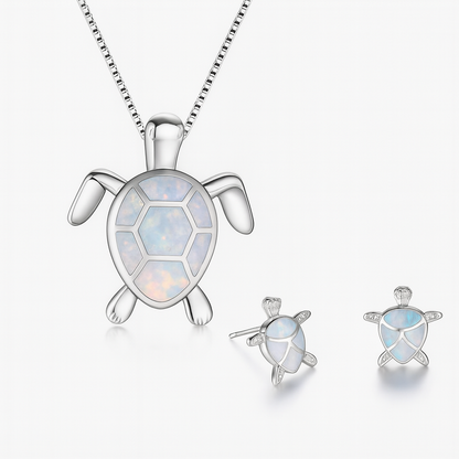 Silver turtle jewelry set with opal inlay, featuring a necklace and matching earrings. Elegant ocean-themed accessories for women.