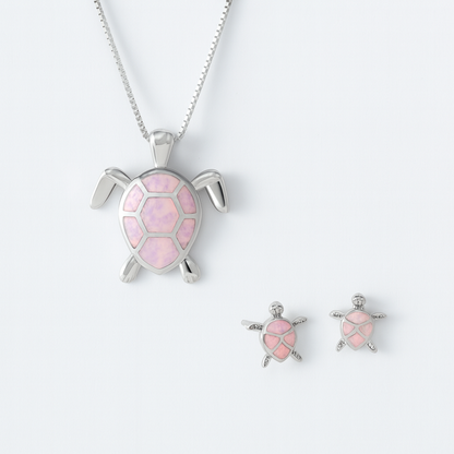 Silver turtle jewelry set with pink opal inlay, featuring a necklace and matching earrings. Elegant ocean-themed accessories for women.