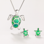 Turtle jewelry set with green opal inlay, featuring a silver turtle pendant necklace and matching earrings, perfect for ocean-themed fashion.