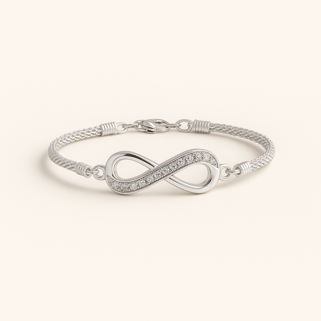 Silver infinity bracelet on a light beige background