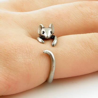 Silver mouse-shaped ring on a finger