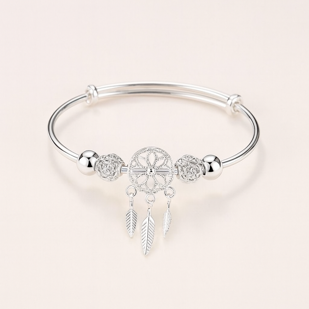 Silver dreamcatcher charm bracelet with intricate feather pendants, elegant design, perfect for boho fashion, women's jewelry accessory.