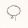 Silver bracelet with a heart charm on a white background