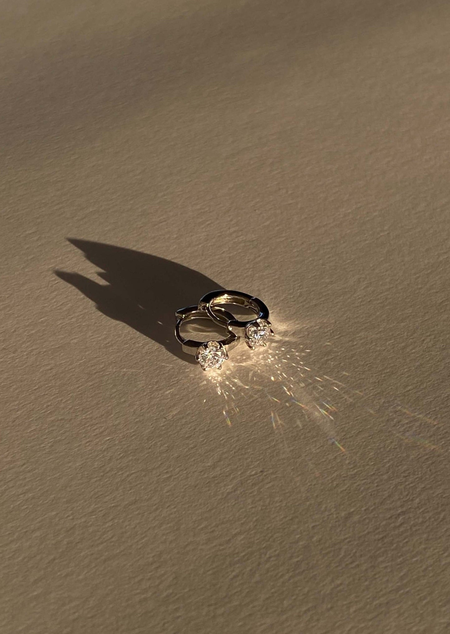 Two rings on sand with a sparkler