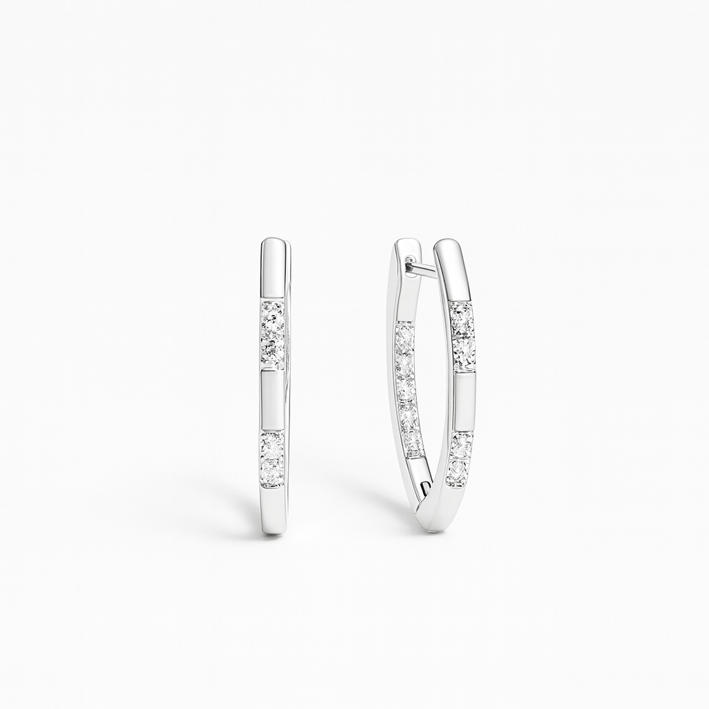 Pair of silver hoop earrings with small diamonds on a white background