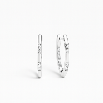Pair of silver hoop earrings with small diamonds on a white background