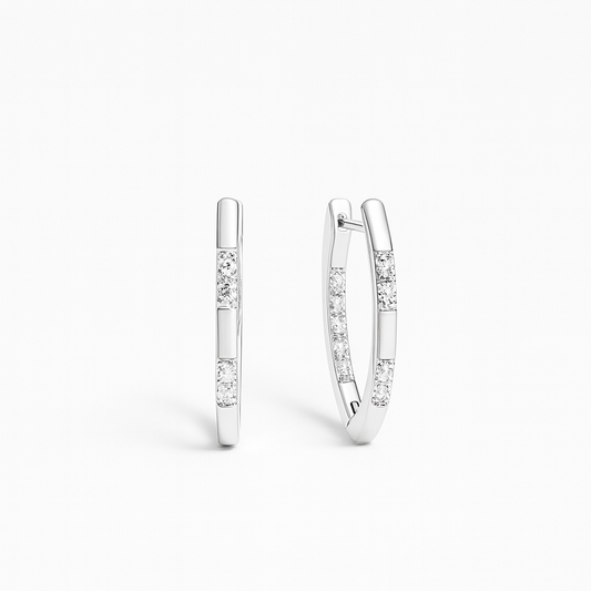 Pair of silver hoop earrings with small diamonds on a white background