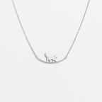 Silver cat pendant necklace on delicate chain, minimalist jewelry design, perfect for cat lovers, elegant accessory for everyday wear.