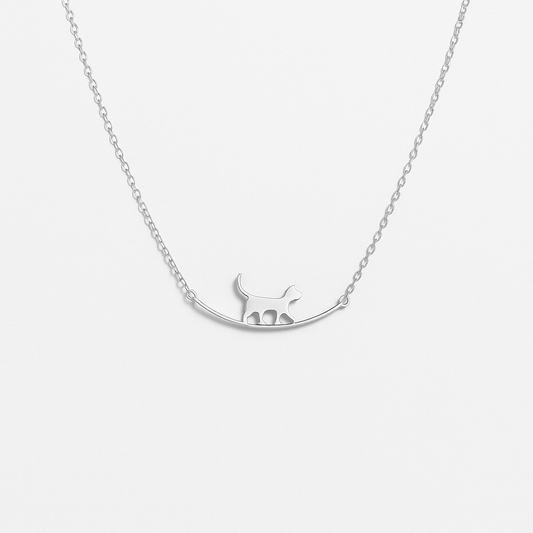 Silver cat pendant necklace on delicate chain, minimalist jewelry design, perfect for cat lovers, elegant accessory for everyday wear.