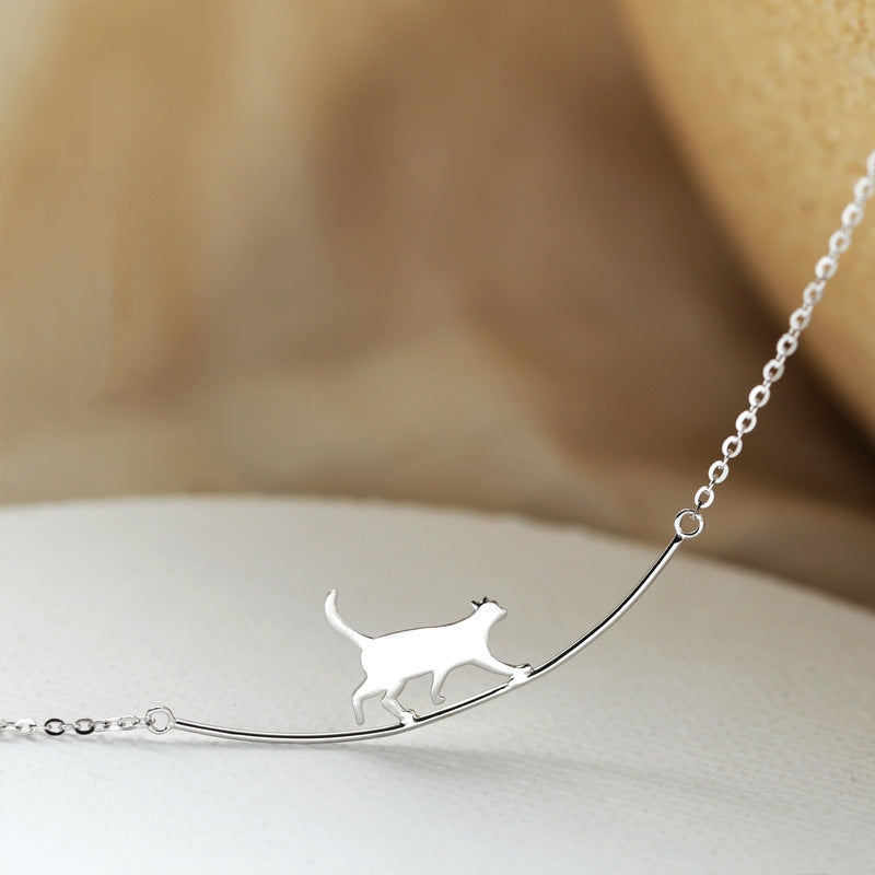 Silver cat pendant necklace on a delicate chain, featuring a minimalist cat silhouette design. Perfect for cat lovers and fashion jewelry enthusiasts.