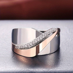 Elegant silver and rose gold ring with diamond accents, featuring a modern wave design. Perfect for weddings, engagements, or luxury fashion.