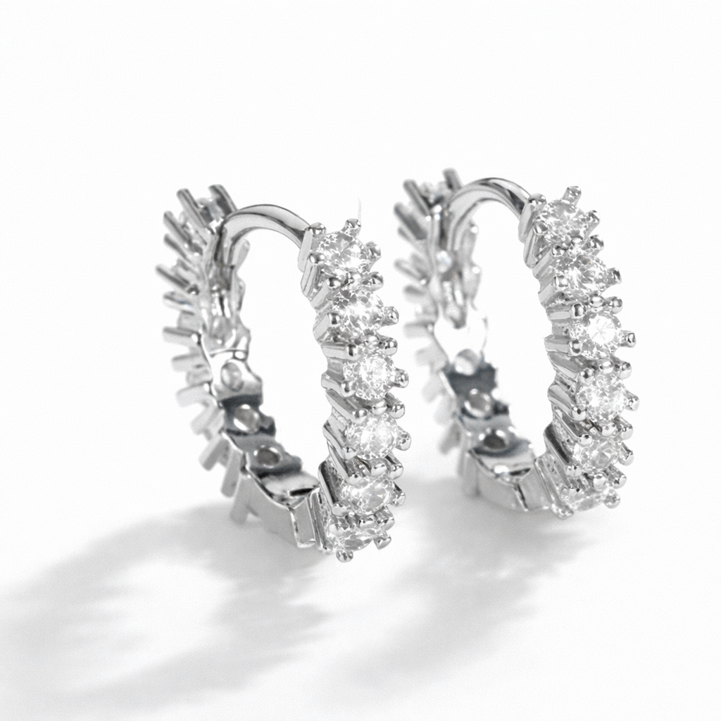 Silver hoop earrings with diamond accents on a white background