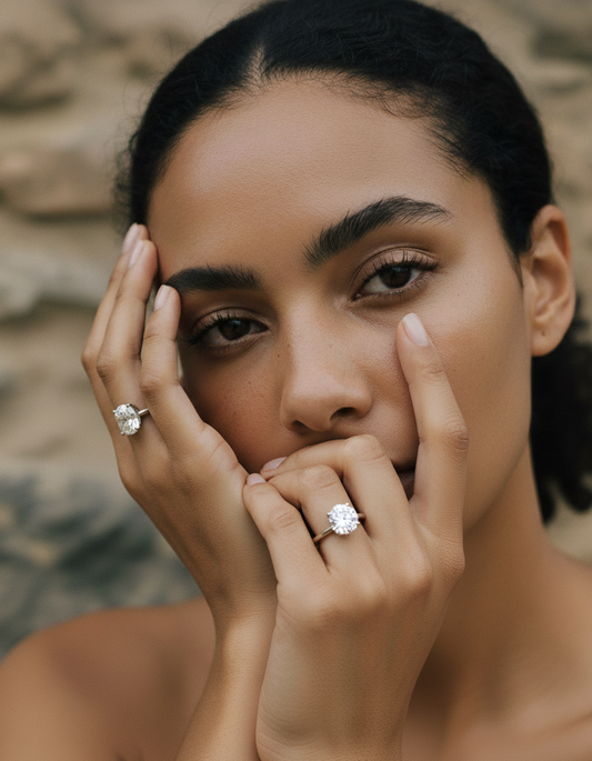 Woman showcasing elegant diamond rings on both hands, close-up portrait. Luxury jewelry, fashion accessories, sophisticated style.