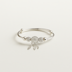 Silver bracelet with a dreamcatcher charm on a light gray background