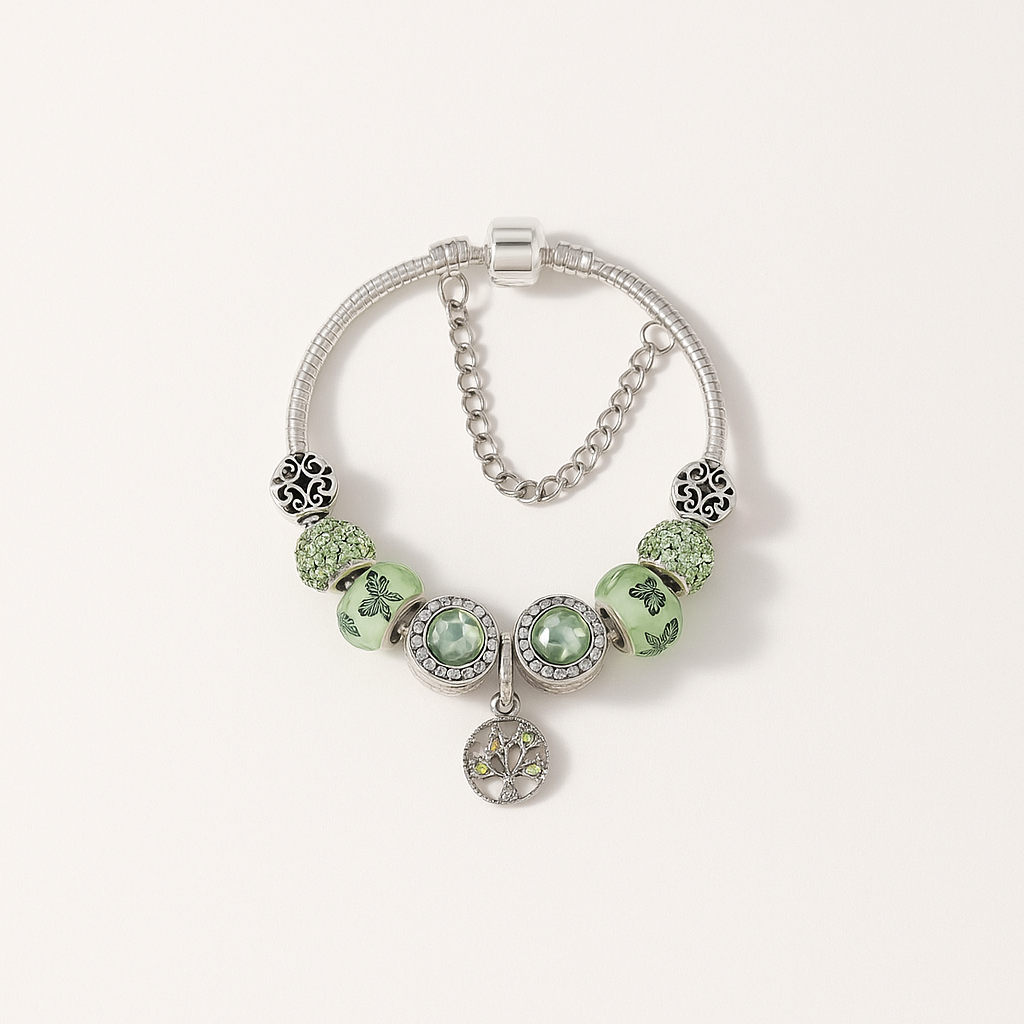 Silver charm bracelet with green beads and intricate designs, featuring a tree of life pendant. Elegant jewelry accessory, perfect for fashion enthusiasts.