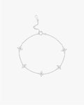 Silver bracelet with star-shaped charms on a light gray background